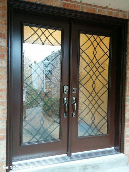 Double front entry steel insulated exterior doors. Brown. Oak Ridge wrought iron glass inserts
